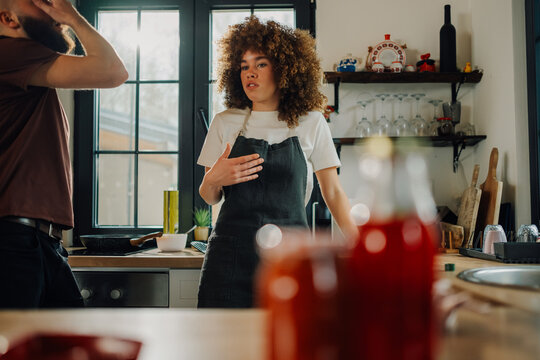 Young chefs having a disagreement while cooking in restaurant kitchen