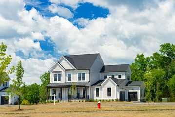 modern family house with big lawn in the foreground, summer day blue sky.