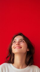 Obraz premium beautiful girl beautiful young woman smiling on red background with copy space vertically 9:16