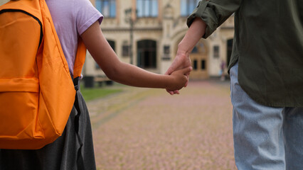 Mom child together going school class elementary education teach kid African American little girl daughter female schoolgirl pupil student with backpack walk hold mother hand first lesson family day