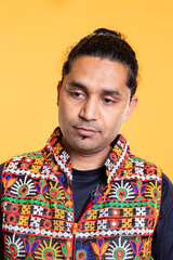 Fototapeta premium Pensive man reflecting, lost in daydreaming process, isolated over studio background. Distracted indian person in traditional clothing fantasizing, using imagination, studio backdrop