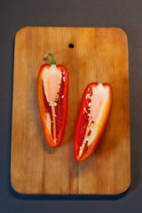 Halved Red Jalapeño Pepper on Bamboo Board