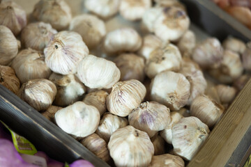 Garlic in basket on counter in market closeup