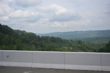 Green landscape view with clouds