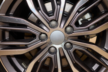 Detailed shot of a sleek black and silver alloy wheel on a motor vehicle