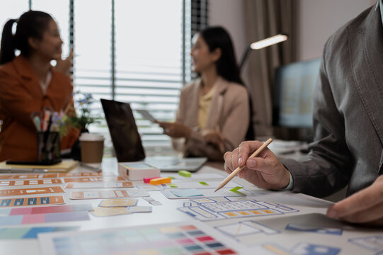 drawing website ux ui app for mobile phone application and development template layout, UI development, designer team working on a project of ux ui in creative office, team of creative web