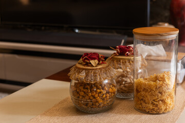 Three glass transparent cookie jar with decorative rose flower cap