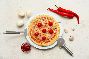 Tasty pizza, cutter and ingredients on light background