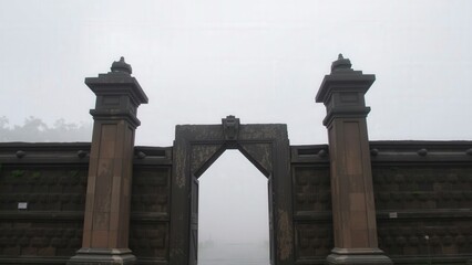 Mystical Gateway: A Hauntingly Beautiful Entrance in the Fog