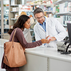 Drugstore, pharmacist and helping woman by counter for pills side effects, prescription drugs...