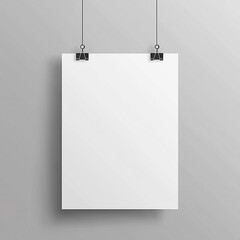 A blank white poster hangs on a gray wall, held by black clips.