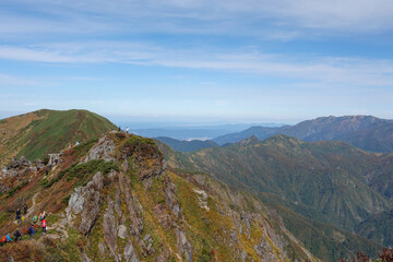 Fototapeta premium Fall Mt. Tanigawa, Gunma, Japan view from the first peak tomano mimi, Mt. Asahidake in the back
