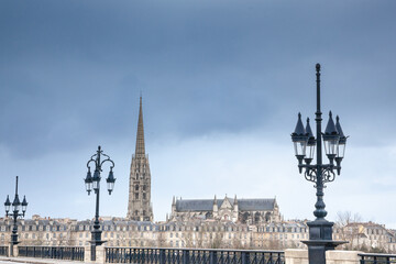 Against a cloudy afternoon sky, Bordeaux reveals a panorama of historic rooftops & the soaring...