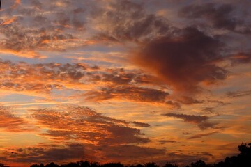 Fototapeta premium Beautiful fiery orange sunset in the sky, natural background