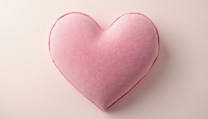 Fototapeta premium Soft pink heart-shaped pillow on a pastel background for decorative purposes