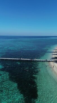 Aerial seascape view of Kanawa Island beach surrounded by turquoise ocean water.