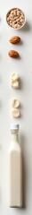 Fototapeta premium Fresh Almond Milk with Nuts and Ingredients on a White Surface Capturing the Essence of Healthy and Natural Plant-Based Dairy Alternatives