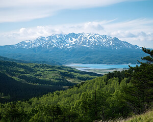 Obraz premium Majestic Snow-capped Mountain Range Overlooking Serene Lake and Lush Green Forest