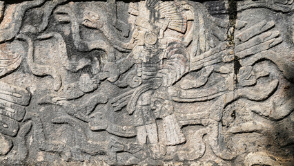 Obraz premium Warrior with snakes relief on the Tzompantli or Platform of Skulls,dedicated to the display of skulls of slain enemy warriors in the temple complex of Chichen Itza,Mayan Ruins,Yucatan,Mexico