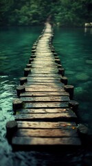 Obraz premium Wooden path across a serene lake in lush forest.