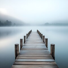 Fototapeta premium Wooden Dock Extending into Misty Lake Landscape