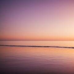 Obraz premium A tranquil seascape during the golden hour with soft sunlight reflecting off the ocean's surface. The sky has warm tones of orange, pink, and purple.