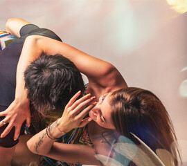Naklejka premium Young couple performing acrobatic dance figure with passion and