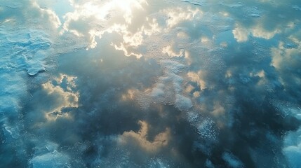 Fototapeta premium A serene reflection of clouds on a calm water surface, creating a tranquil atmosphere.