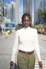 Fototapeta premium Confident Woman in Stylish Casual Outfit Posing in an Urban Setting