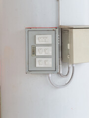Metal box for electrical switch control panel mounted on a white wall