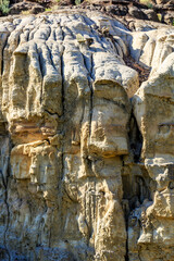 A rocky cliff with a lot of cracks and crevices