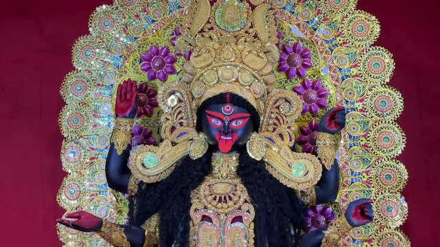 Footage of Maa Kali Idol with golden and red background.