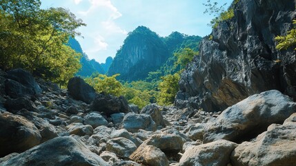 A stunning 4K shot of Chang Phuek beneath a rocky mountain. The large boulders and rugged terrain create a stark contrast with the peaceful greenery of the valley,