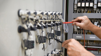Electrical engineer inspects electrical control equipment	