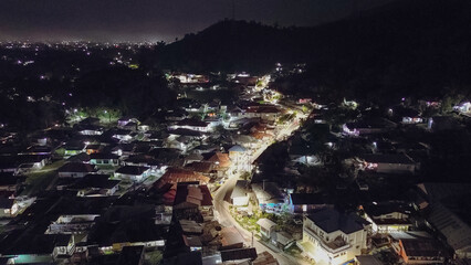 Aerial view of a small town in the mountains at night.