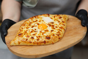 Khachapuri is a dish of Georgian cuisine in Adjarian style. Baked bread with cheese and egg filling.