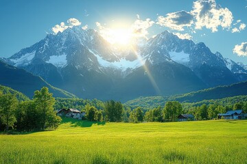 Obraz premium Picturesque Alpine Meadow with Majestic Snow-Capped Mountain Range and Sunbeams
