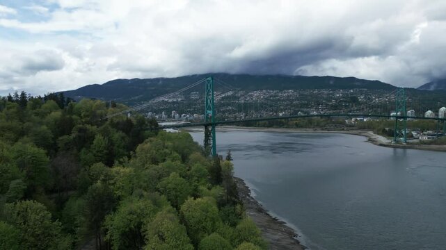 aerial shot over stanley park with the Lions Gate Bridge and north vancouver in the background, Vancouver City, British Columbia, Canada