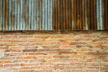 Red brick wall background and old zinc rust top.