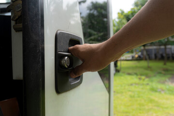 Naklejka premium the hand that opens or closes the bus door