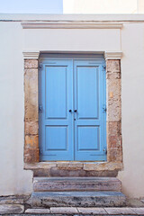 Fototapeta premium Front view Athens house, blue wooden door
