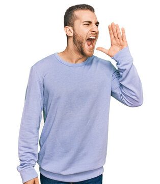 Young caucasian man wearing casual clothes shouting and screaming loud to side with hand on mouth. communication concept.