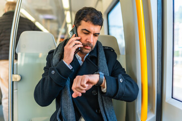 Businessman checking the time while commuting with metro