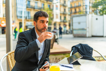 Businessman enjoying morning coffee in an outdoor cafeteria