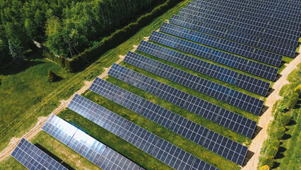 Bright sunset over solar farm Aerial drone captures solar panels