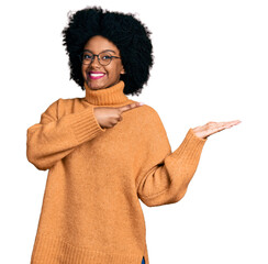 Young african american woman wearing casual clothes amazed and smiling to the camera while...