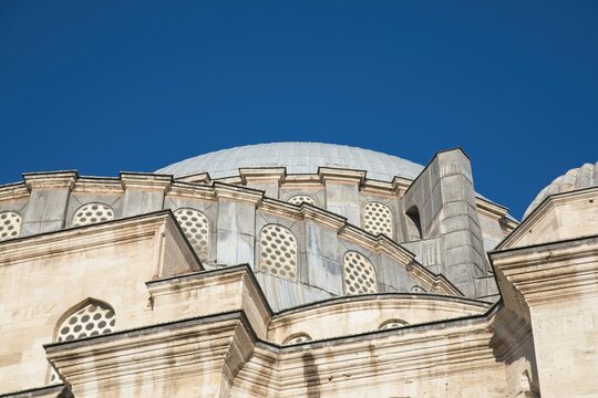 Closeup of the dome and window architecture of the Sulemaniye mosque against deep blue sky