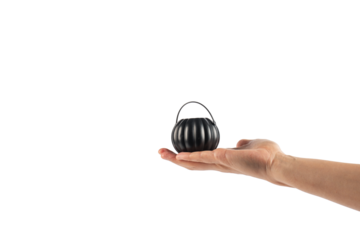 Halloween pumpkin-shaped plastic cup in hand, transparent background