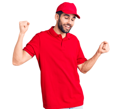Young handsome man with beard wearing delivery uniform dancing happy and cheerful, smiling moving casual and confident listening to music