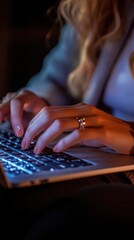 Fototapeta premium Woman Working on Laptop at Night Cozy Atmosphere Home Office Typing Keys Illuminated Keyboard